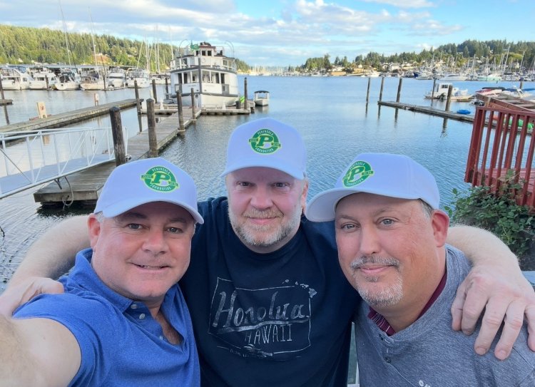 Golfers behind event sign